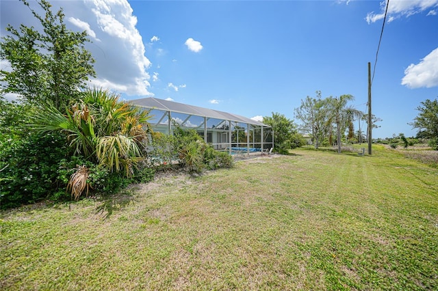 2193 Beacon Dr, Port Charlotte, FL 33952 - view of green lawn featuring glass enclosure and a swimming pool