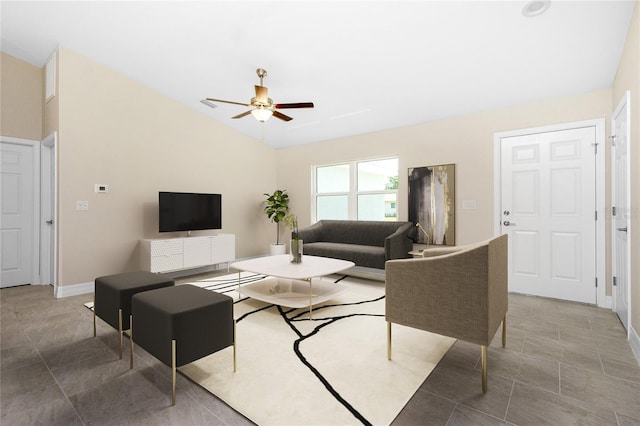 living area featuring ceiling fan, lofted ceiling, and baseboards