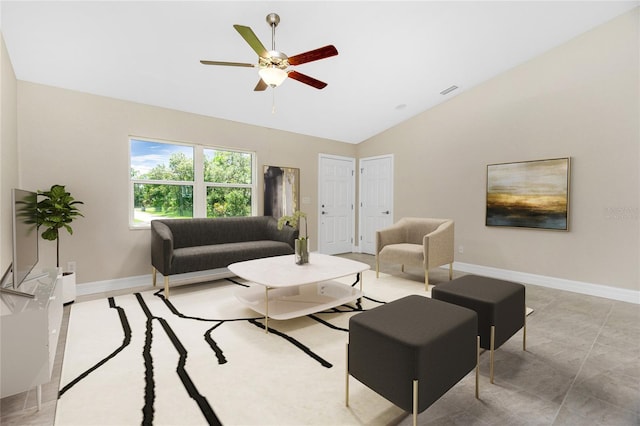 living area with vaulted ceiling, a ceiling fan, and baseboards
