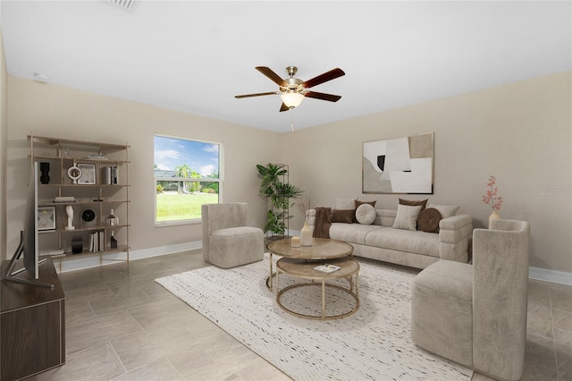 living area featuring a ceiling fan and baseboards
