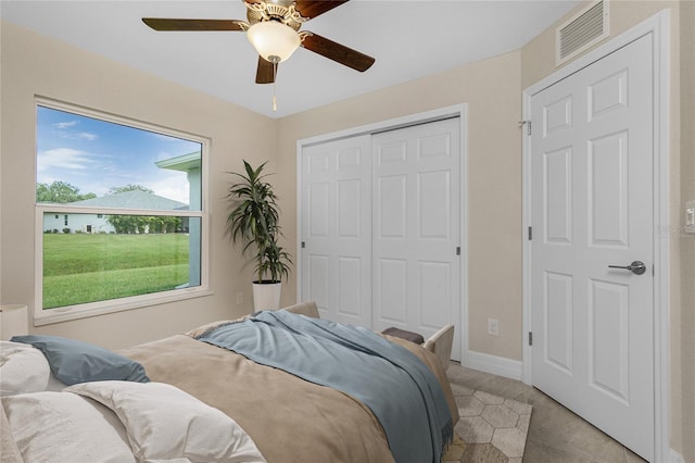 bedroom with a closet, a ceiling fan, and baseboards
