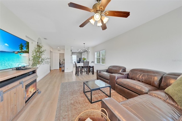 2160 Heron Lake Dr Unit 201, Punta Gorda, FL 33983 - living area featuring light wood-style flooring, a ceiling fan, a chandelier, and baseboards