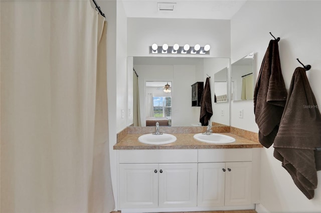 2160 Heron Lake Dr Unit 201, Punta Gorda, FL 33983 - ensuite bathroom with double vanity and a ceiling fan