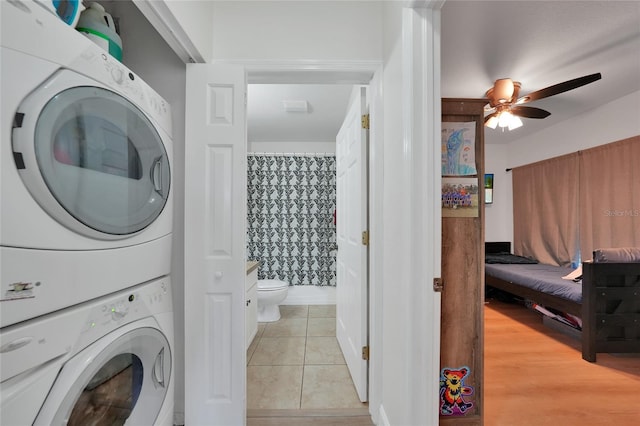 2160 Heron Lake Dr Unit 201, Punta Gorda, FL 33983 - laundry area with stacked washing machine and dryer, a ceiling fan, and light tile patterned floors