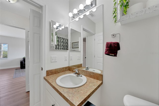 2160 Heron Lake Dr Unit 201, Punta Gorda, FL 33983 - full bath featuring toilet, wood finished floors, and vanity