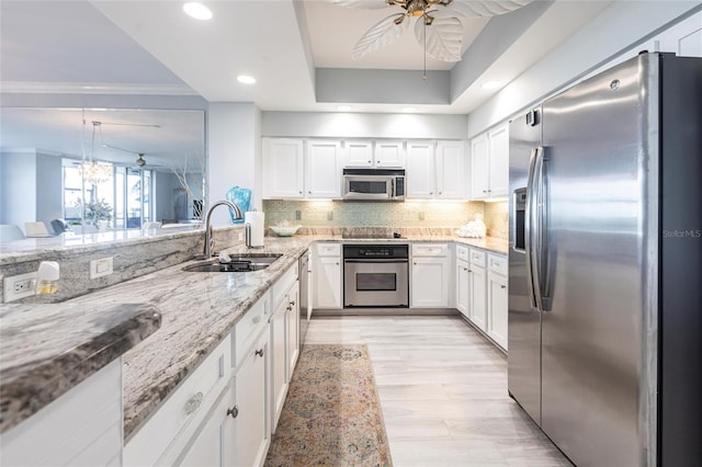 3329 Sunset Key Cir Unit 107, Punta Gorda, FL 33955 - kitchen featuring stainless steel appliances, a sink, light stone countertops, white cabinets, and recessed lighting