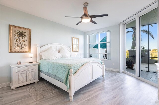 3329 Sunset Key Cir Unit 107, Punta Gorda, FL 33955 - bedroom featuring access to outside, light wood-style flooring, baseboards, and ceiling fan