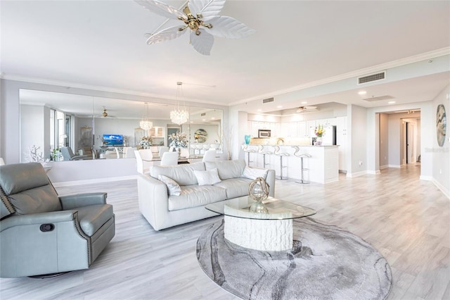 3329 Sunset Key Cir Unit 107, Punta Gorda, FL 33955 - living room with a ceiling fan, light wood-type flooring, crown molding, and baseboards