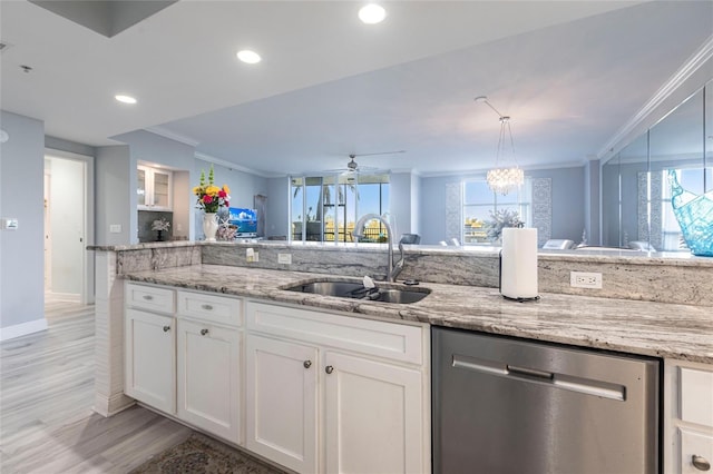 3329 Sunset Key Cir Unit 107, Punta Gorda, FL 33955 - kitchen featuring dishwasher, a sink, crown molding, light wood-type flooring, and white cabinets