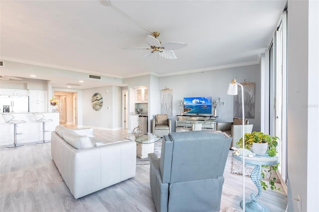 3329 Sunset Key Cir Unit 107, Punta Gorda, FL 33955 - living area featuring ceiling fan, light wood-type flooring, crown molding, and baseboards