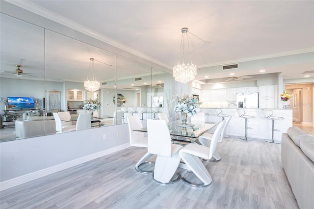 3329 Sunset Key Cir Unit 107, Punta Gorda, FL 33955 - dining space featuring a chandelier, a ceiling fan, light wood-style flooring, and ornamental molding