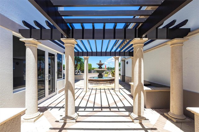 3329 Sunset Key Cir Unit 107, Punta Gorda, FL 33955 - view of patio / terrace featuring a pergola and french doors