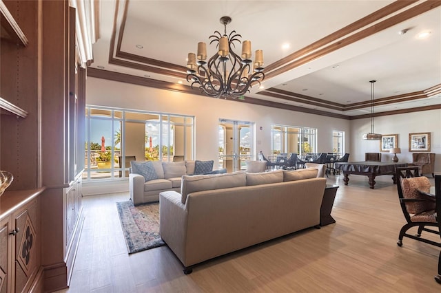 3329 Sunset Key Cir Unit 107, Punta Gorda, FL 33955 - living area with a raised ceiling, crown molding, healthy amount of natural light, wood finished floors, and french doors
