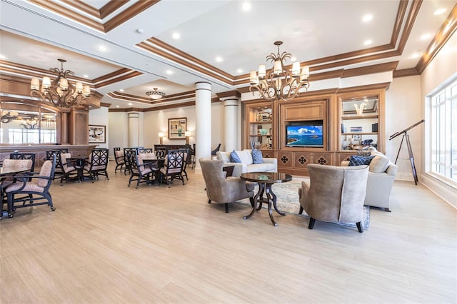 3329 Sunset Key Cir Unit 107, Punta Gorda, FL 33955 - living area featuring a chandelier, plenty of natural light, crown molding, light wood finished floors, and a raised ceiling
