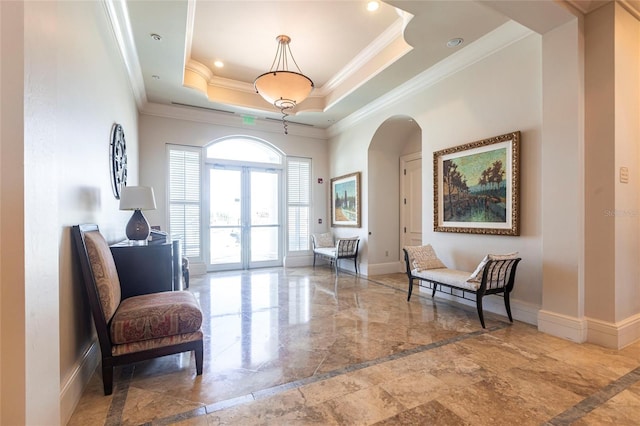 3329 Sunset Key Cir Unit 107, Punta Gorda, FL 33955 - living area featuring ornamental molding, french doors, arched walkways, marble tiled floors, and a raised ceiling