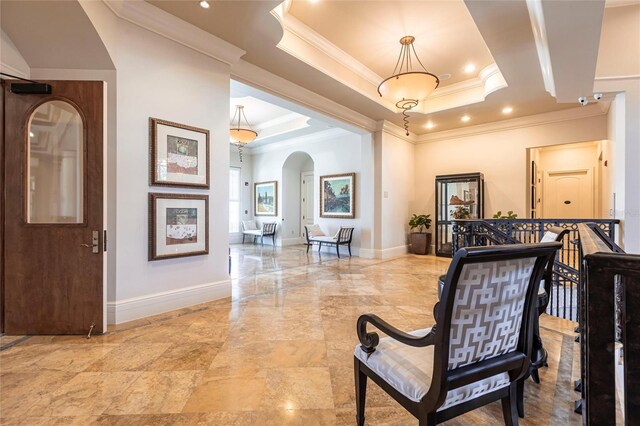 3329 Sunset Key Cir Unit 107, Punta Gorda, FL 33955 - corridor featuring arched walkways, a raised ceiling, ornamental molding, baseboards, and recessed lighting