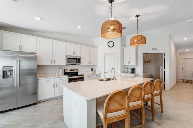 14267 Heritage Landing Blvd Unit 1223, Punta Gorda, FL 33955 - kitchen featuring stainless steel appliances, a sink, a breakfast bar, light countertops, and white cabinetry