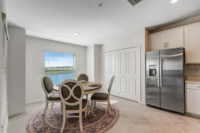 14267 Heritage Landing Blvd Unit 1223, Punta Gorda, FL 33955 - dining space featuring light tile patterned floors, recessed lighting, a textured ceiling, and baseboards