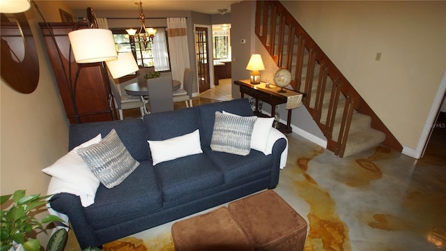 925 Fenton Ln Unit 11, Lakeland, FL 33809 - living room featuring stairway, a chandelier, baseboards, and finished concrete flooring