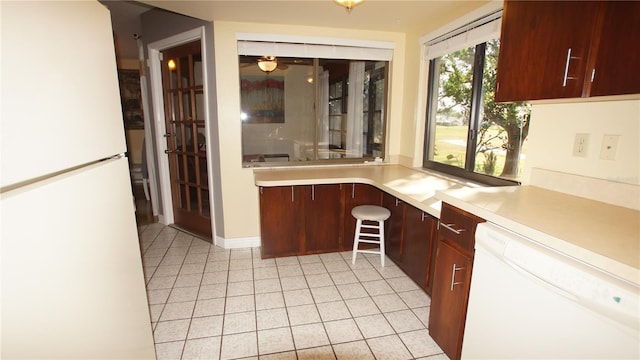 925 Fenton Ln Unit 11, Lakeland, FL 33809 - kitchen featuring white appliances, light tile patterned flooring, and light countertops