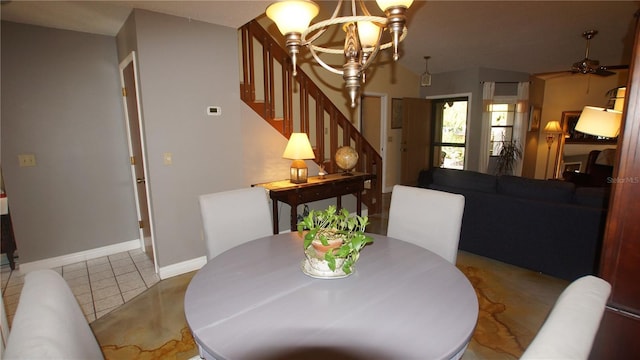 925 Fenton Ln Unit 11, Lakeland, FL 33809 - dining space with stairs, a chandelier, a ceiling fan, baseboards, and tile patterned floors