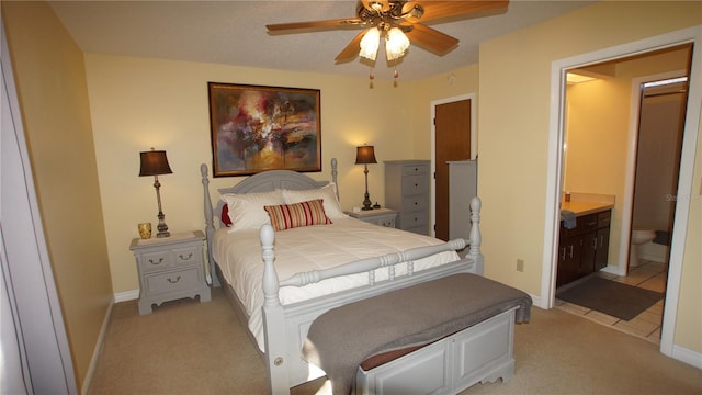 925 Fenton Ln Unit 11, Lakeland, FL 33809 - bedroom featuring light carpet, baseboards, connected bathroom, and a ceiling fan