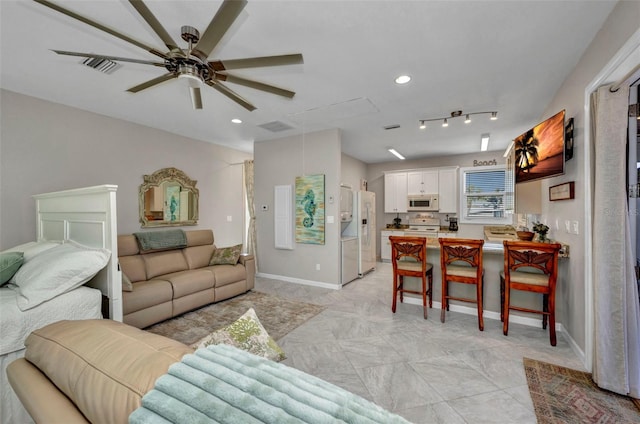 4231 Hollis Ave, Port Charlotte, FL 33953 - living room featuring a ceiling fan, baseboards, and recessed lighting