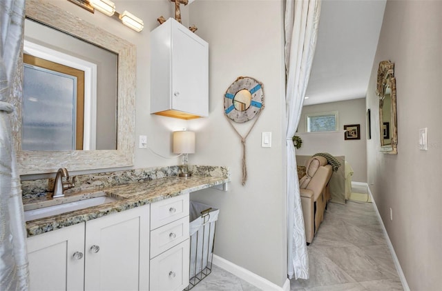 4231 Hollis Ave, Port Charlotte, FL 33953 - bathroom with baseboards, vanity, and marble look tile flooring