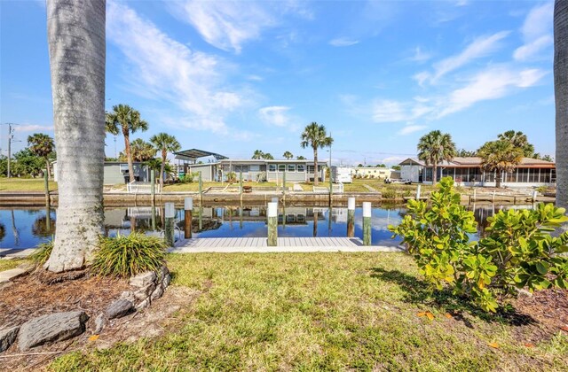 4231 Hollis Ave, Port Charlotte, FL 33953 - dock area with a water view, a residential view, and a yard