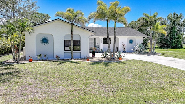 16615 Acapulco Rd, Punta Gorda, FL 33955 - view of front of home with stucco siding, a front yard, and driveway