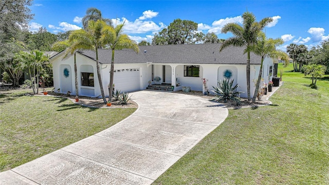 16615 Acapulco Rd, Punta Gorda, FL 33955 - ranch-style house featuring stucco siding, a garage, driveway, and a front lawn