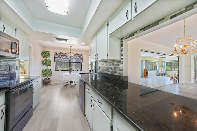 16615 Acapulco Rd, Punta Gorda, FL 33955 - kitchen featuring a chandelier, stainless steel appliances, a sink, and decorative backsplash