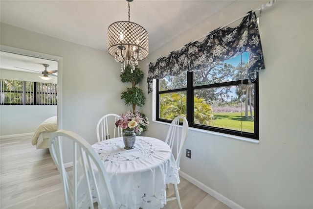 16615 Acapulco Rd, Punta Gorda, FL 33955 - dining space with baseboards, wood finished floors, and a chandelier