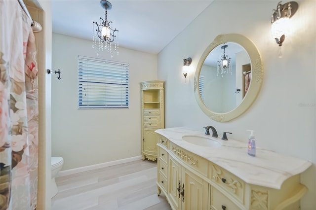 16615 Acapulco Rd, Punta Gorda, FL 33955 - full bathroom with a chandelier, baseboards, vanity, and toilet