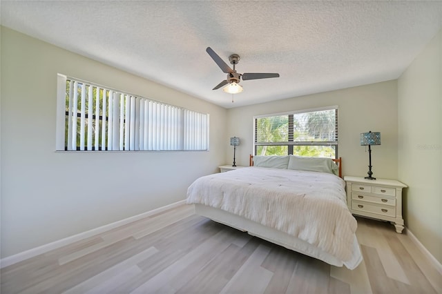 16615 Acapulco Rd, Punta Gorda, FL 33955 - bedroom with baseboards, wood finished floors, a textured ceiling, and a ceiling fan
