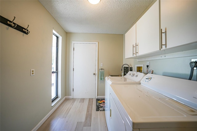 16615 Acapulco Rd, Punta Gorda, FL 33955 - laundry area with cabinet space, independent washer and dryer, light wood-style floors, healthy amount of natural light, and a textured ceiling
