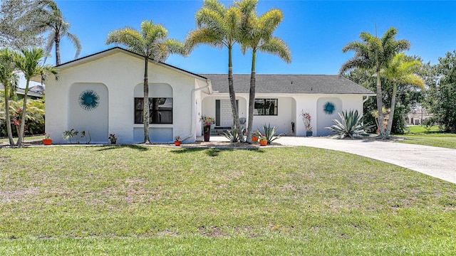 16615 Acapulco Rd, Punta Gorda, FL 33955 - view of front of property featuring stucco siding, a front yard, and concrete driveway