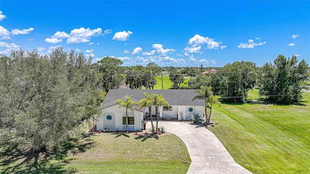 16615 Acapulco Rd, Punta Gorda, FL 33955 - view of front facade featuring concrete driveway and a front lawn