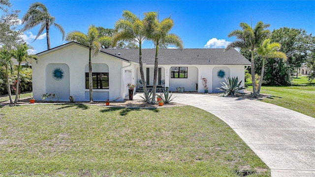 16615 Acapulco Rd, Punta Gorda, FL 33955 - view of front facade featuring stucco siding, a front lawn, and concrete driveway