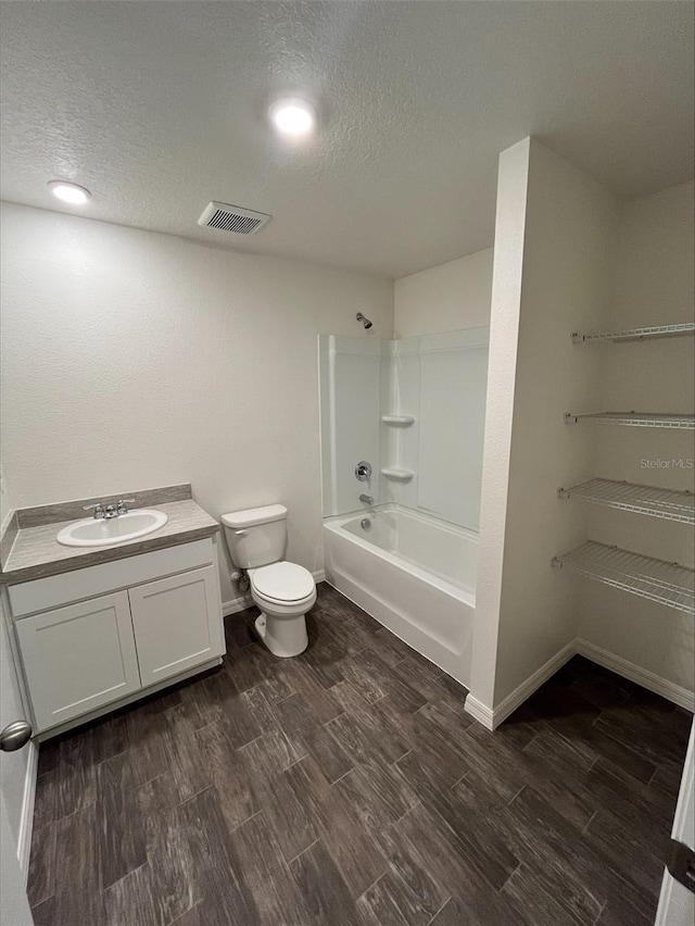 4200 Wanda St, Hastings, FL 32145 - bathroom featuring wood finished floors, a textured ceiling, toilet, vanity, and  shower combination