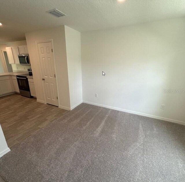 26 Postwood Dr, Palm Coast, FL 32164 - carpeted spare room featuring baseboards, recessed lighting, and a textured ceiling