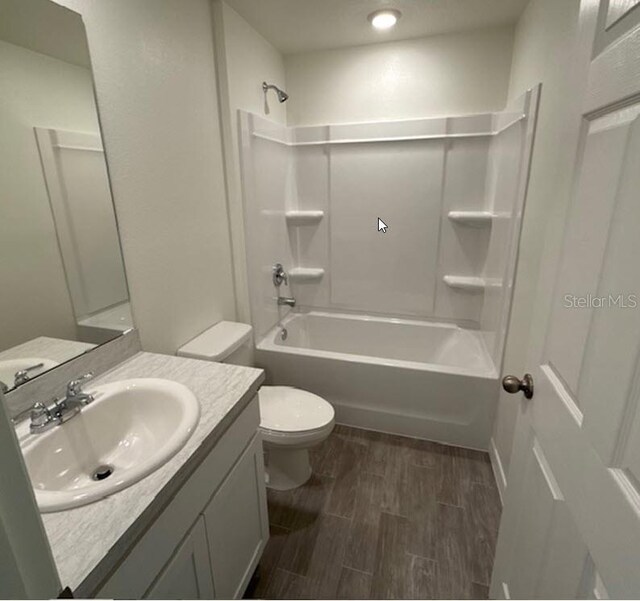 26 Postwood Dr, Palm Coast, FL 32164 - bathroom with toilet, wood finished floors, shower / bathtub combination, and vanity