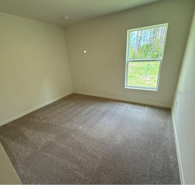26 Postwood Dr, Palm Coast, FL 32164 - unfurnished room with plenty of natural light, baseboards, and carpet