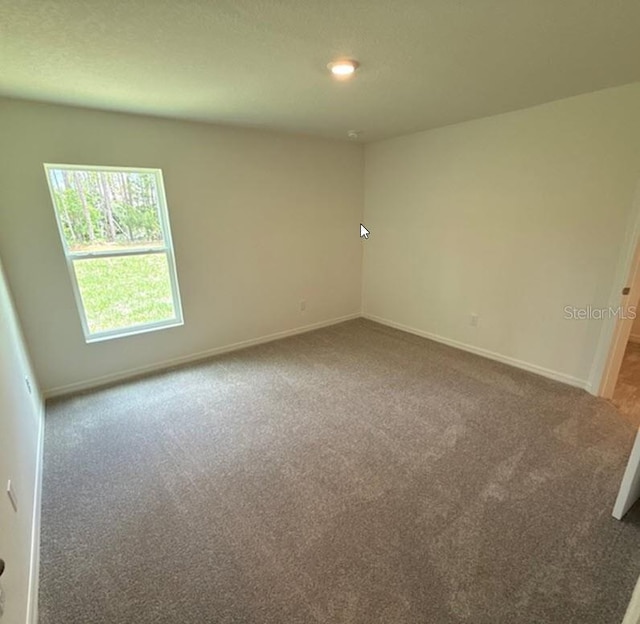 26 Postwood Dr, Palm Coast, FL 32164 - carpeted empty room featuring baseboards
