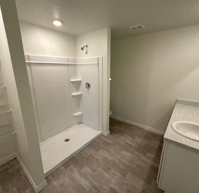 26 Postwood Dr, Palm Coast, FL 32164 - bathroom with walk in shower, vanity, baseboards, and toilet