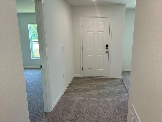 hallway with carpet and baseboards