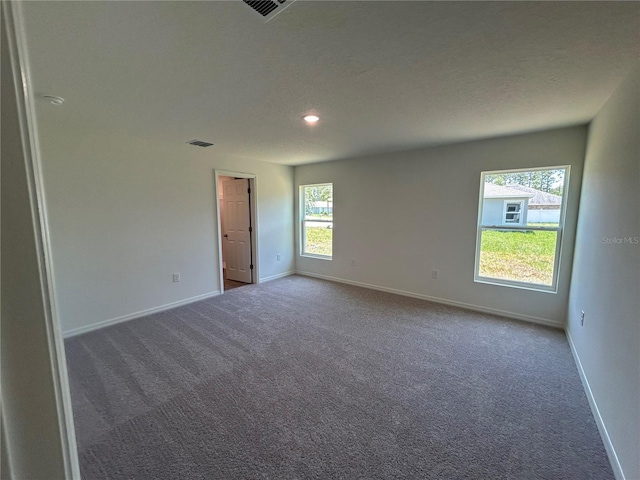 unfurnished room with carpet, baseboards, recessed lighting, and a textured ceiling