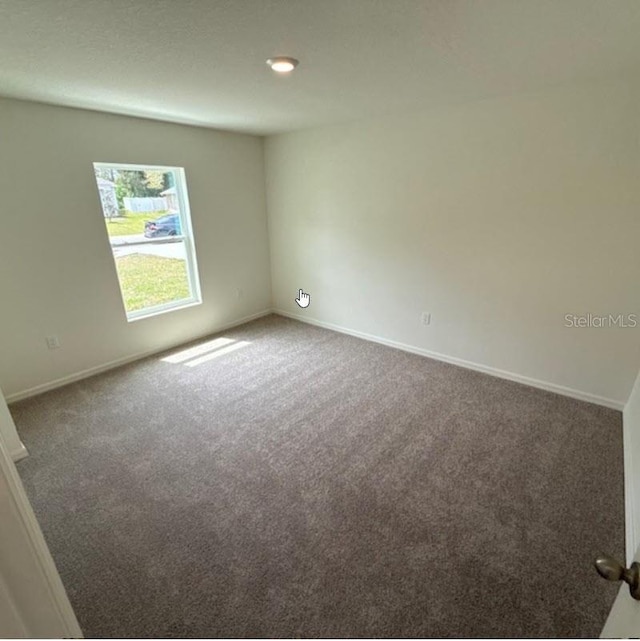 empty room with carpet and baseboards