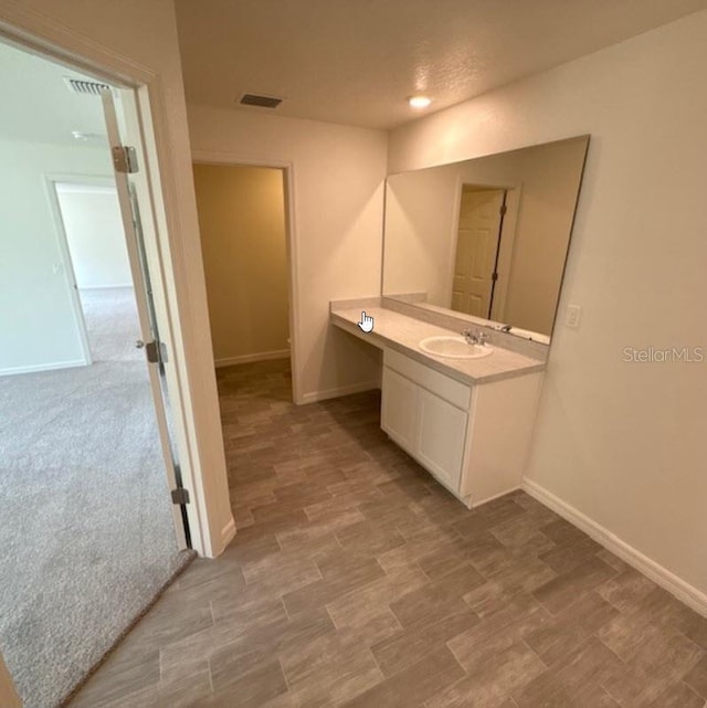 bathroom with baseboards and vanity