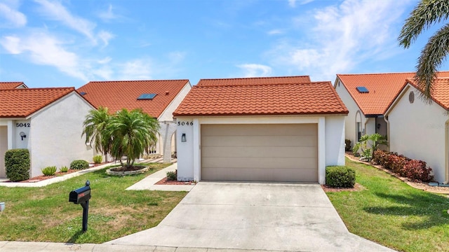 5046 San Rocco Ct, Punta Gorda, FL 33950 - mediterranean / spanish house featuring stucco siding, a tiled roof, a garage, and concrete driveway